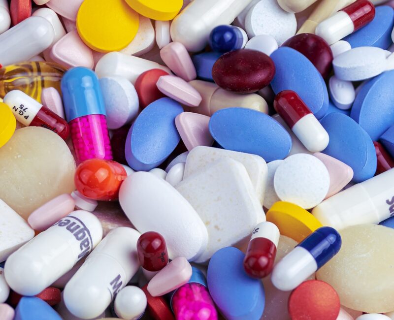white blue and orange medication pill